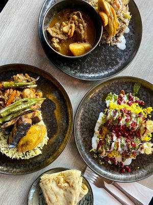 Starting from the left clockwise: codfish & okra, goat curry, jerk chicken, and roti at Jam Delish in North London