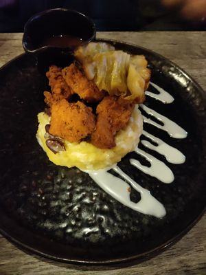 Fried chikin on mash with cabbage and beans at Jam Delish in North London