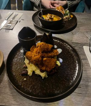 Fried chicken with hispi cabbage and Jamaican gravy  at Jam Delish in North London