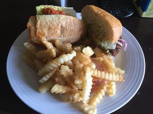 Half of their buffalo sub, half an impossible burger, and a whole lot of fries at Loving Hut in Tampa