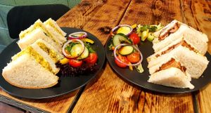 Coronation Chickpea and a Sausage and Caramalised Onion Chutney Sandwich with a salad dressing at Cafe Zero + Purely Vegan Bistro in Bridgnorth