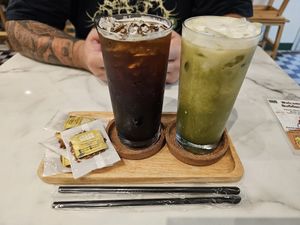 Iced Matcha & American with complimentary biscuits at Began Vegan in Bangkok