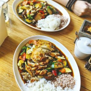 Front: Crispy mock duck (really mock chicken imho) with fresh veggies and a chili ginger sauce.
Back: wok veggies with mock chicken in hoisin sauce.
Both with two types of rice. at Well Being in Cologne
