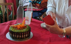 Our friend getting excited about her new 'cakey' experience surprise -getting ready to photograph it. at Fakey Cakey in London