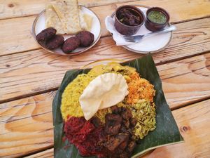Weekday curry plate, pigeon pea fritters, paper-thin bread, green sauce (a must!) And eggplant. at Mirisata in Portland