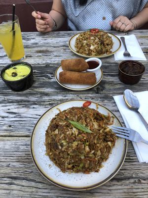From left: potato curry, passion fruit soda, chk’n kottu, seeni sambal, spicy chk’n kottu, beef rolls w/devil sauce   at Mirisata in Portland