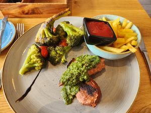 Vegan steak with charred broccoli and fries at Aarmühle in Interlaken