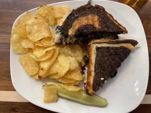 Portobello Reuben with subbed vegan cheese and chips side  at Jules' Bistro in St Cloud