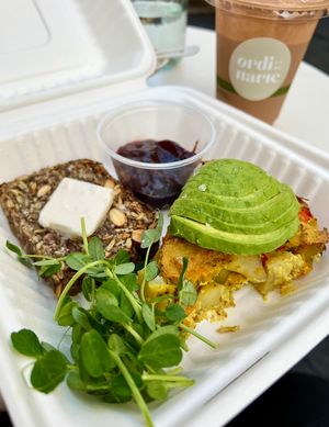 Weekend Special! Breakfast platter with Norwegian seed bread, vegan frittata, avo and pea shoots (AMAZING!!!! 🙌🏼) ‘Nice Cream Truck’ strawberry smoothie in the back.   at Ordinarie Fare in Dayton