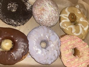 Cookies n cream, vanilla glaze, gingerbread, cookie dough, lavender lemon, strawberry shortcake   at Sojo's Donuts in Mesa