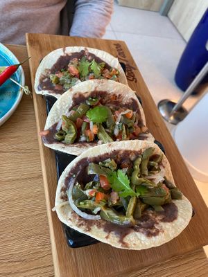 Tortillas with refried beans at Sexy Tacos in 
