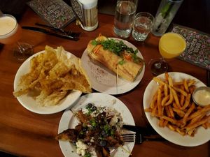table full of deliciousness-- 'Rabbit's Foot' & 'Swell Gifts' drinks, pork rinds, Bahn mi, bbq chicken skewers, & fries at Cloak & Dagger in Cleveland