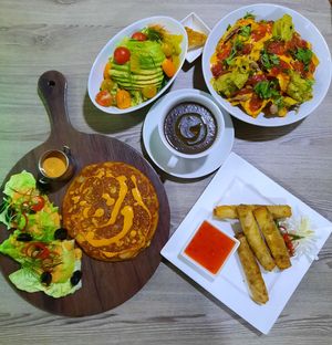 Spanish Omlette, spring rolls, wild mushrooms soup, orange avicado salad and loaded Nachos all vegan with olant based protein  at Just Vegan - Marina Walk Pearl in Dubai