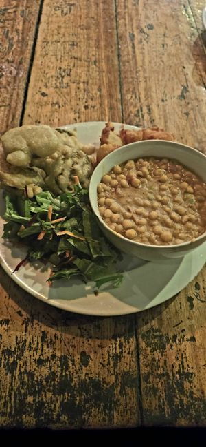 Yellow dahl, yellow peas, eggplant fritters and salad at The Mushroom Farm in Livingstonia