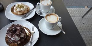 Custard and pistaccio cake (top), dark chocolate, cream and cherry cake (bottom) and coffee. at efrem in Turin