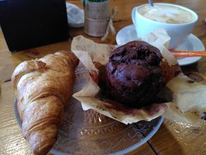 Croissant, chocolate muffin and coffee with oat milk at Hemen Cafeteria in Arrasate