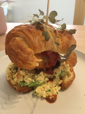 Breakfast croissant with scrambled tofu, hash brown avocado and mushroom- excellent  at Plant Vibes Cafe in Bowen Hills