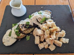 Pear and eggplant appetizer with sourdough at SER Restaurante in Nosara