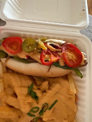 Philly cheesesteak dog (peppers, onions, mayo) with a side of cheese fries at Frankly Plant Based Kitchen in Toledo