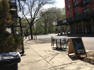 View of front of burger place, plus Thomkins Sq. Park at Pop's Eat-Rite in New York City