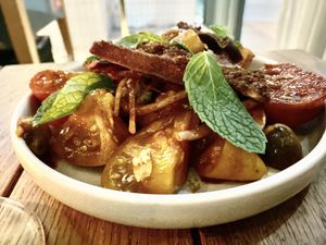 Tomato salad, mint, red onion and olives with paprika vinaigrette and pitta crisps. Who thought a tomato salad could be this good!  at ZA ZA TA in Fortitude Valley