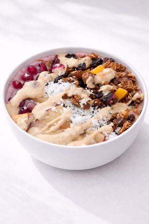 Berry granola smoothie bowl | high-protein | dairy-free | made with berries, banana, house plant milk, granola, fruits & peanut butter. at Tralata in Mumbai