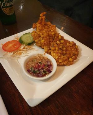 Tod Man Kow Pord 
(sweetcorn cakes with chilli and peanut sauce) at Nahm Prik Thai Cuisine in Altrincham