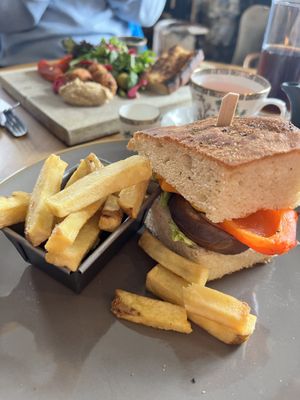 Foreground:  Vegan Focaccia Sandwich with roasted veggies & vegan cheese; served with fries (“chips”)  at The Dunvegan in Isle Of Skye