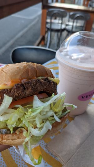 Vegan cheeseburger and orange vegan milkshake!  at Burger Crush in Victoria