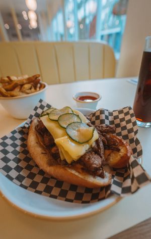 Philly Cheesesteak with Rudy's Fries and a Cola. at Rudy's Vegan Butcher & Diner in North London