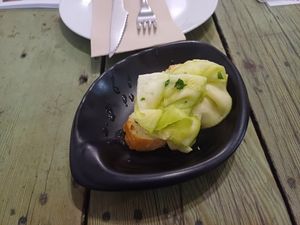 Bread with sliced marinated leeks (I think), Santa y Pura, 7 November 2024 at Santa y Pura in Madrid