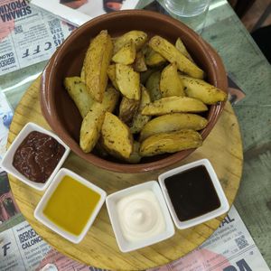 Patatas 4 salsas at Santa y Pura in Madrid