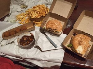 Our meal! Big fries, vegan tartaat, vegan bitterballen, vegan stoofvlees with jack fruit, vegan fried chicken burger & vegan guacamole-sweet-potato burger.  at Friterie Chasse Patat in Ghent