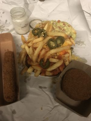 The black mamba: fries, guacamole, tomato sauce, vegan cheddar, jalapeños with a vegan kipkorn and vegan bamischijf   at Friterie Chasse Patat in Ghent