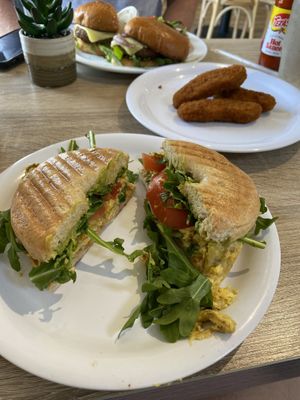 Just Egg breakfast sandwich (with tomato, loads of arugula) / plant-based chicken nuggets / Beyond Burger (with cheese, tomato, arugula, and grilled onion)  at Vine Cafe in New Bern