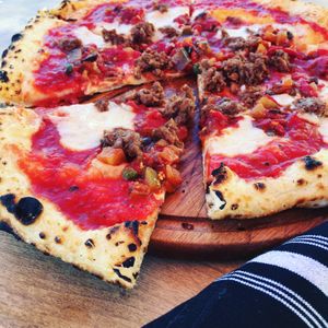 Vegan Seed Releaf Pizza with Miyoko’s plant-based mozzarella, Beyond sausage, caponata, and caramelized onions. at Floodwater - temporarily closed in Mill Valley