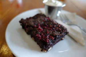 Amazing VEGAN BROWNIE with whipped Cashew cream.  at Cosset in Auckland