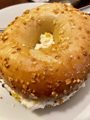 Peach schmear on onion bagel   at Ben & Esther's Vegan Jewish Deli in Portland