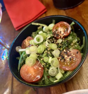 Wakame seaweed salad with spring onions, cherry tomatoes, sesame dressing  at Seven Lucky Gods in Bristol