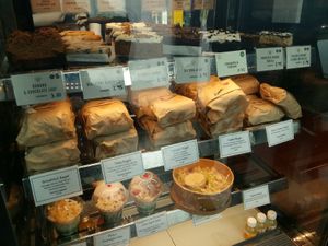 A good selection of cakes, bagels, overnight oats, and some juices; salads had sold out. at The Well Bean Co in East London