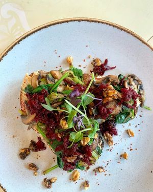 Artisan toast with house hummus, sautéed mushroom, spinach and leek with a beetroot and caramelised walnut crumb. at Aesthete Coffee + Kitchen in Sheffield