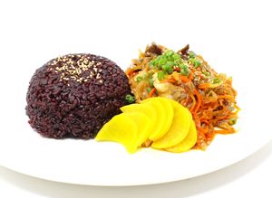 Bulgogi Plate - Assorted mushrooms, carrots, and white onions cooked in sweet-savory sauce, garnished with sesame seeds, oshinko, and green onions at Daikon Vegan Sushi in Las Vegas