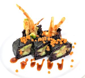 Spider Roll - Tempura friend king mushrooms, avocado, cucumbers, jackfruit salad. Topped with sweet soy, and roes. at Daikon Vegan Sushi in Las Vegas