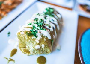 Vegan Wet Burrito ( filled with fresh veggies, vegan rice, black beans, vegan cheese. Topped with Tomatillo green salsa, vegan cheese, fresh cilantro & onion. at Casa Azul Taqueria in Providence