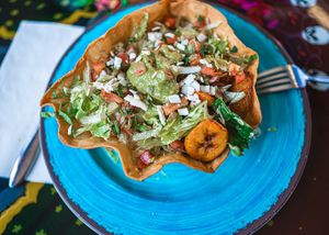 Vegan taco bowl ( crispy taco shell, filled with sweet fried plantains, Vegan rice, black beans, fresh lettuce, pico de Gallo, vegan cheese, vegan sour cream & guacamole.) at Casa Azul Taqueria in Providence