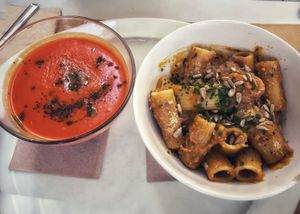 Carrot lemongrass soup and a pumpkin sauce rigatoni at Aguaribay in Barcelona