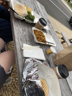 Crunchwraps, home fries, and coffees at their picnic tables outside   at Cats Luck Vegan in Neptune City