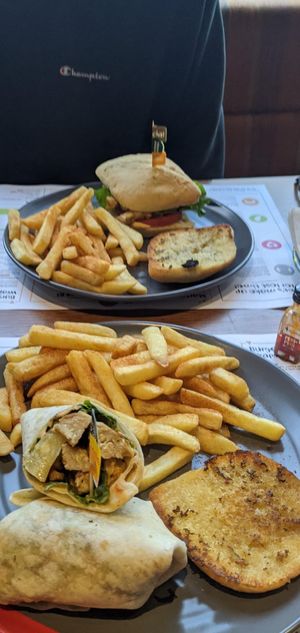 Vegan chicken wrap w peri chips & garlic bread at Nando's in Hatfield