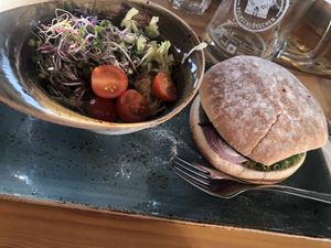 burger plus side: choice of bread (sourdough, multi-grain, or breadleas) and side (mixed green salad, some variation of a cole slaw or french fries) at Hans im Glück in Winterthur
