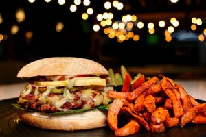 Vexican Beyond Burger (made with beyond meat) With Guacamole, Chorizo, Vegan Cheese, Pineapple. Served with Sweet Potato fries. at Verde Y Rojo in Tijuana